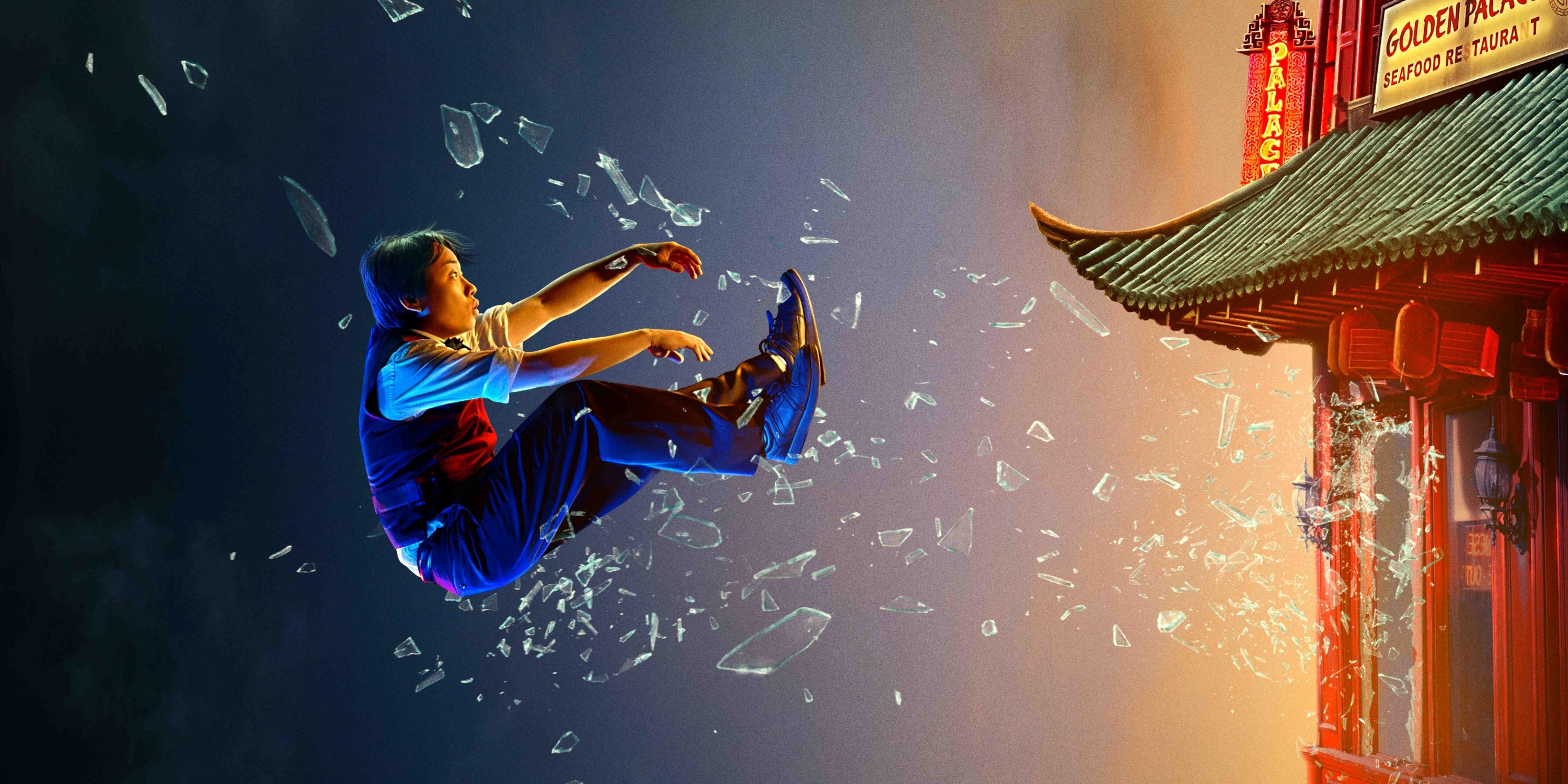 Hulu poster artwork of Jimmy O. Yang floating through a broken window into the air for Interior Chinatown