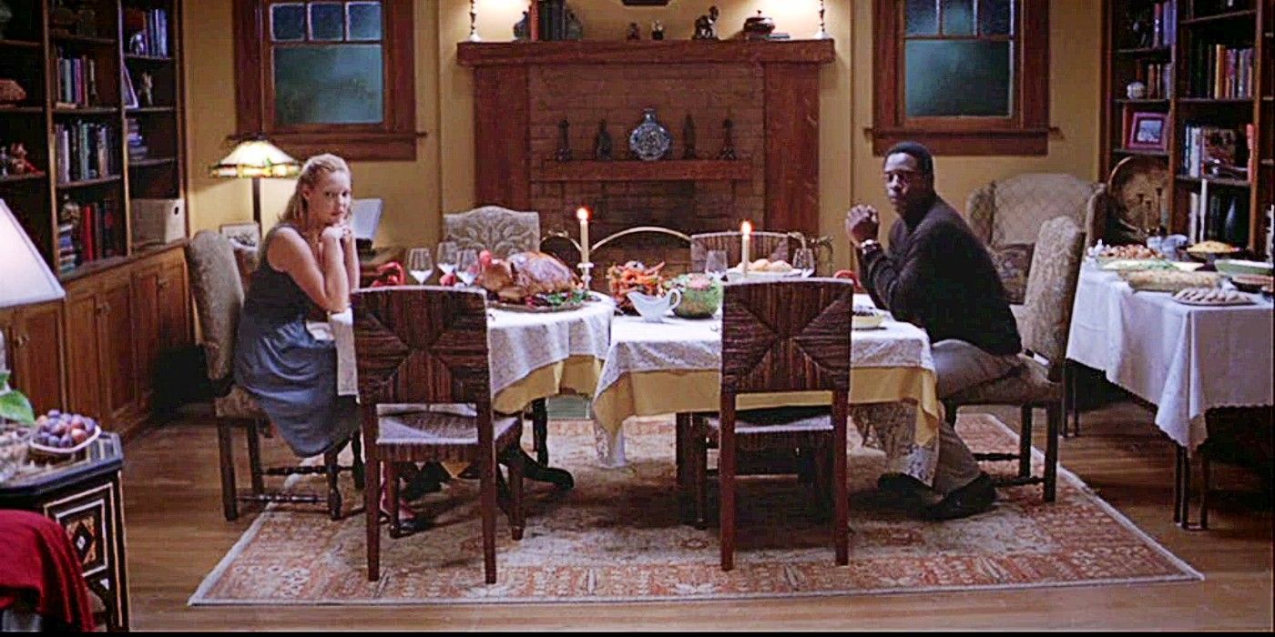 Izzie Stephens and Preston Burke sitting at a dinner table for Thanksgiving dinner in Grey&rsquo;s Anatoomy