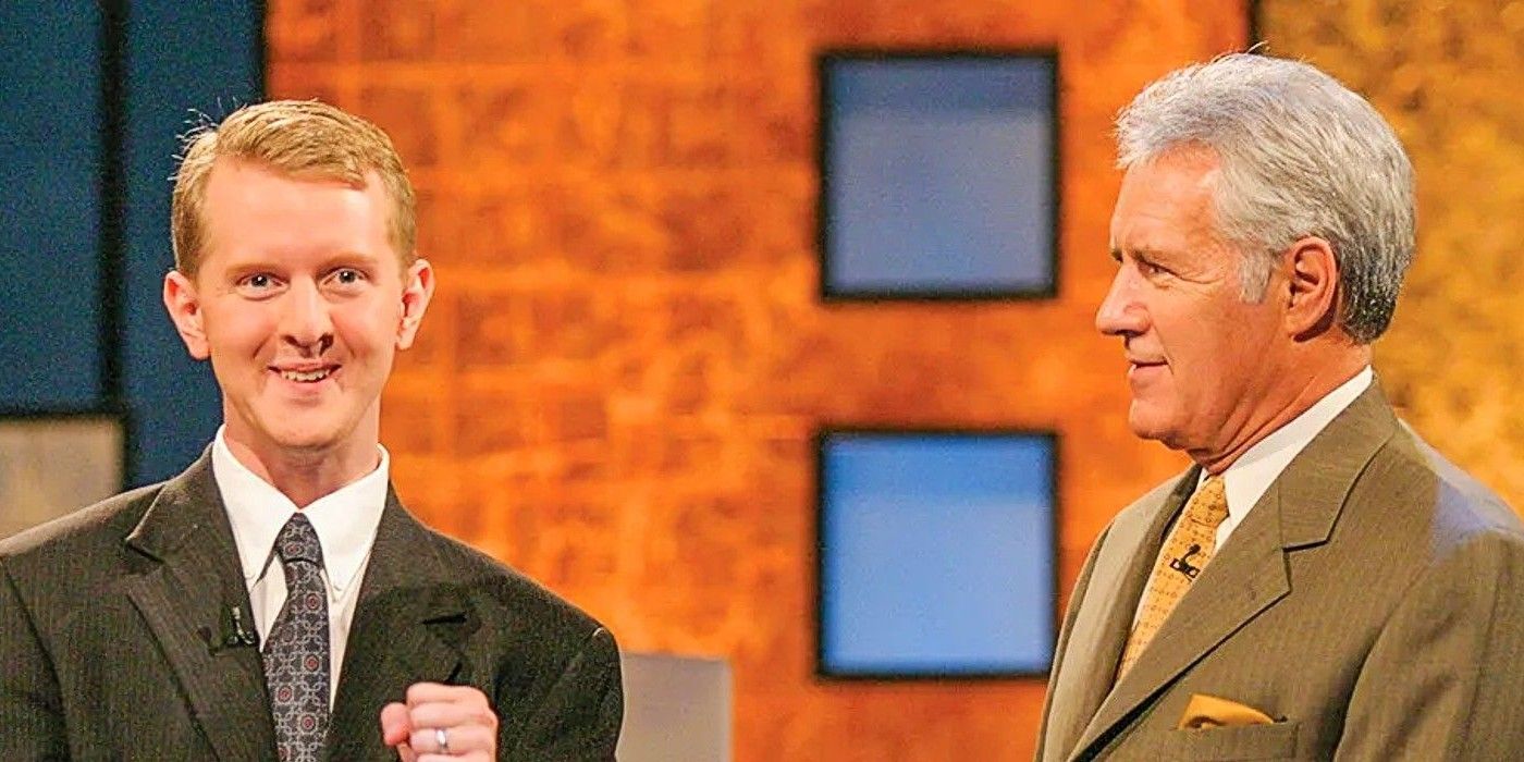 Ken Jennings and Alex Trebek standing on the Jeopardy! stage together-1