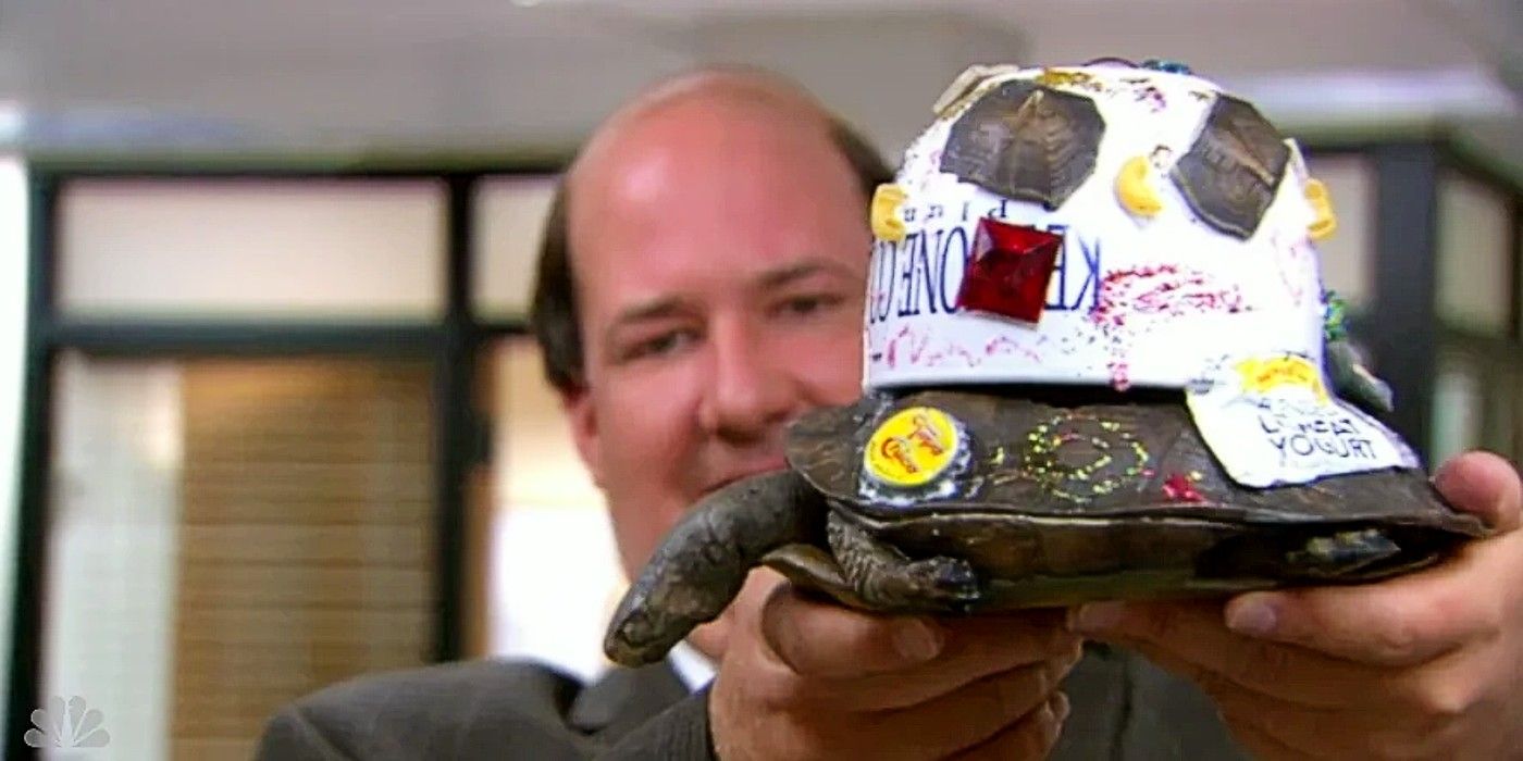 Kevin holding up his reconstructed turtle in The Office Season 9