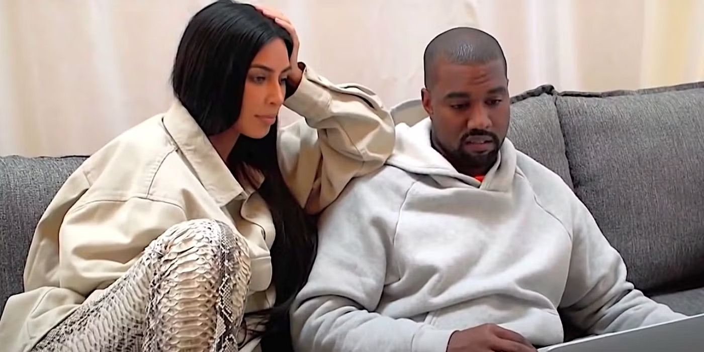 Kim Kardashian and Kanye West sitting on a sofa, looking at a laptop