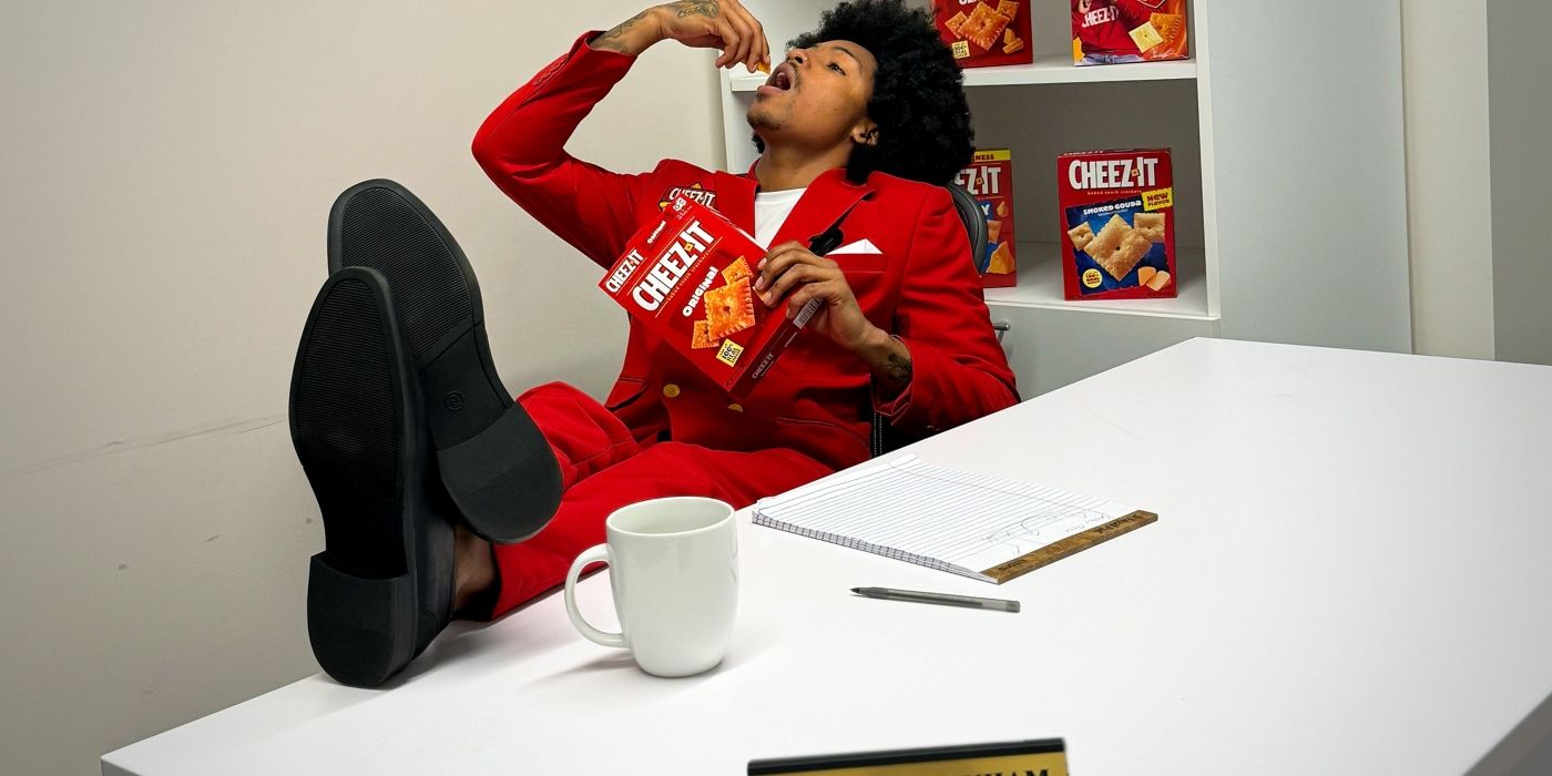 Kordell Beckham sits back as he eats Cheez-It with a box in his hand.