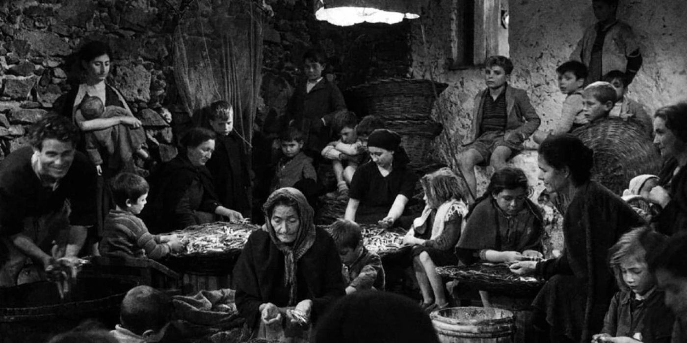 A group of people looking despondent in La Terrra Trema