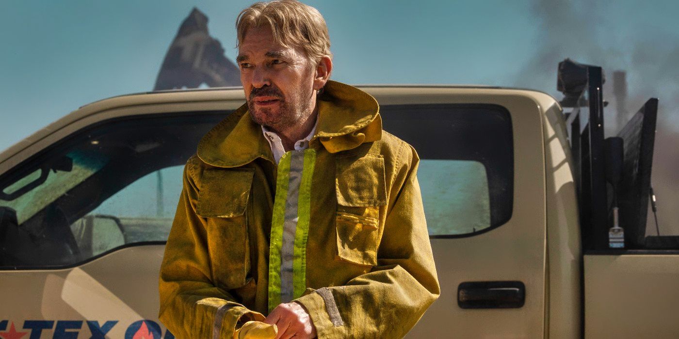 Billy Bob Thornton standing in front of a truck with a work jacket on in Landman.