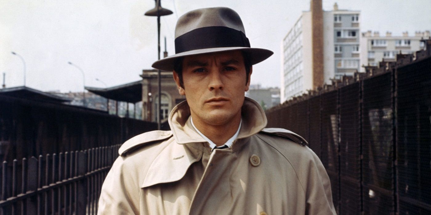 Alain Delon as Jef Costello walking down the street in Le Samourai