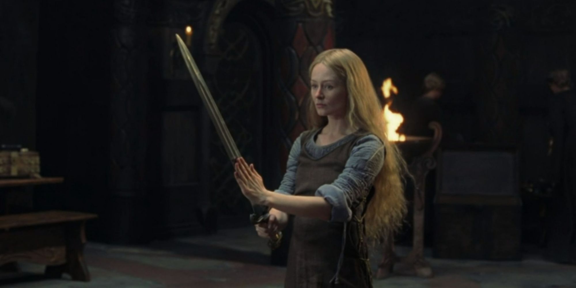 Miranda Otto as ?owyn holding a sword in The Lord of the Rings