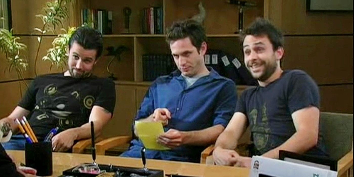 Mac, Dennis, and Charlie sitting behind a desk in It&rsquo;s Always Sunny in Philadelphia Season 3