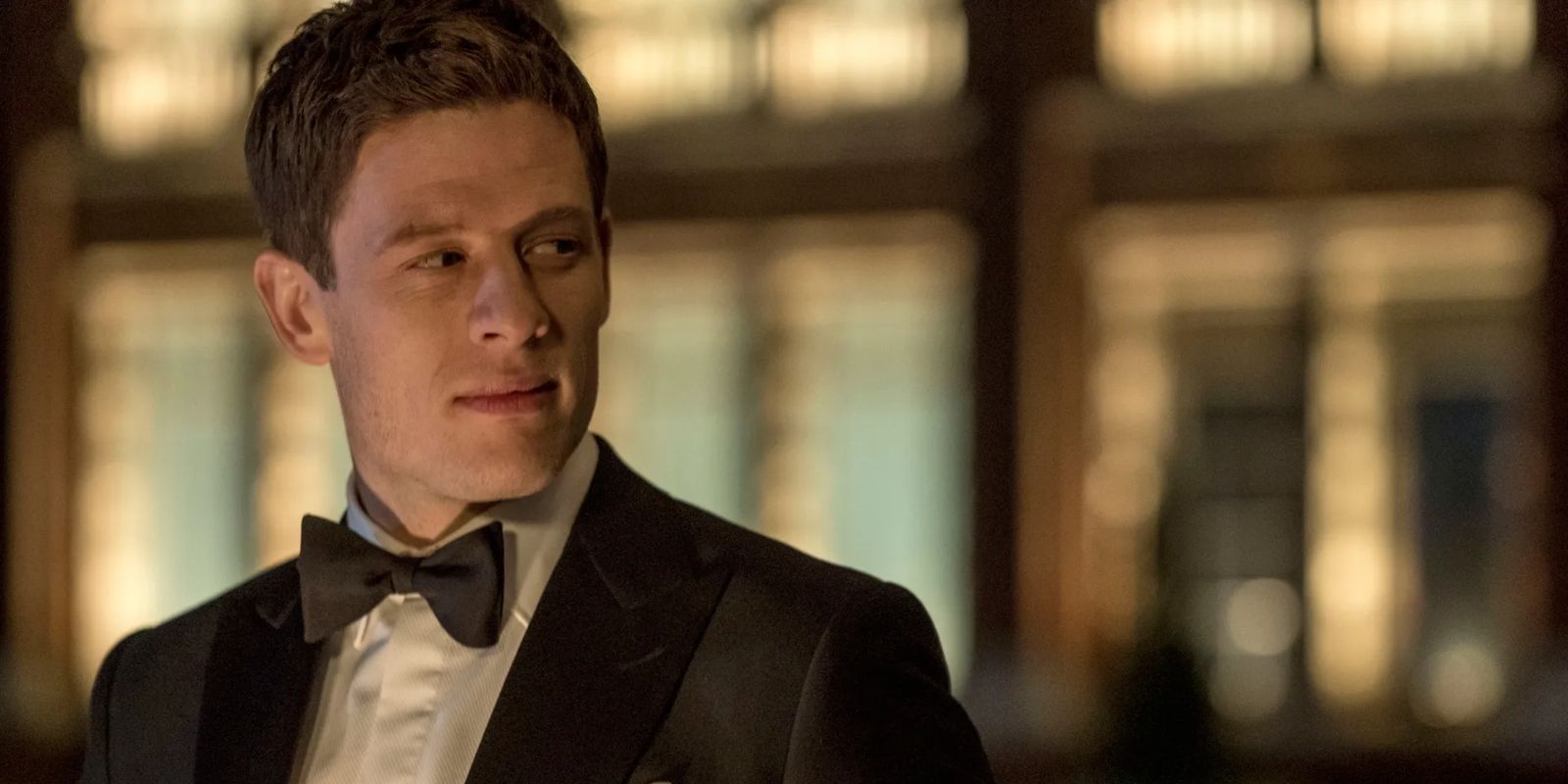 Alex Godman (James Norton) peers over his shoulder while wearing a tuxedo in 'McMafia' (2018).