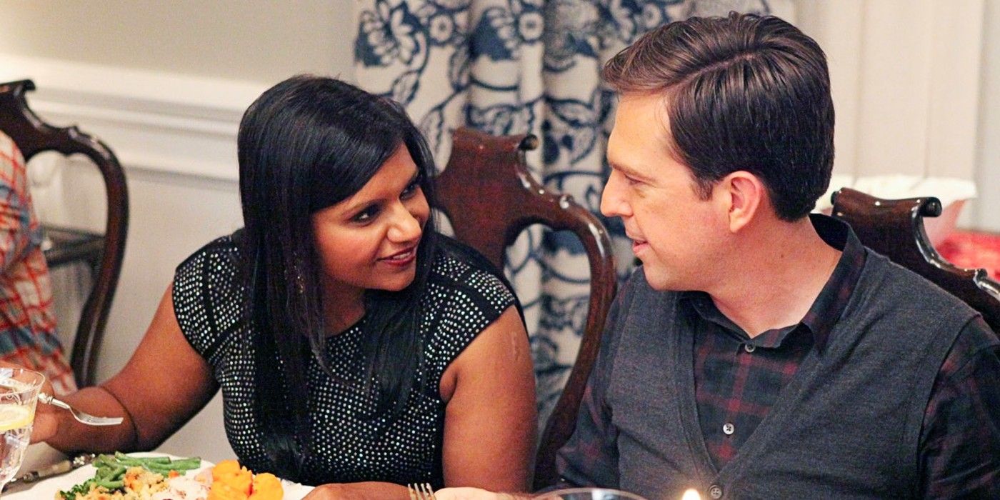 Mindy and Dennis sitting next to each other at Thanksgiving dinner in The Mindy Project