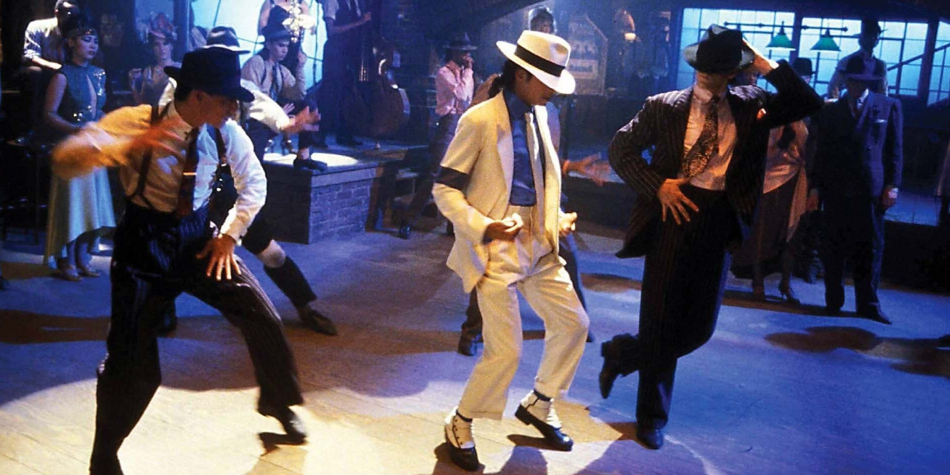 Michael Jackson dancing in a white suit and hat in Moonwalker