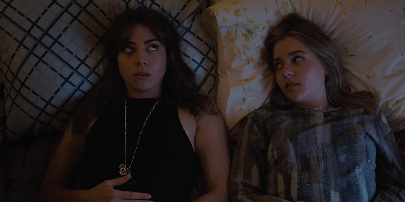 Aubrey Plaza and Maisy Stella laying in bed together in My Old Ass