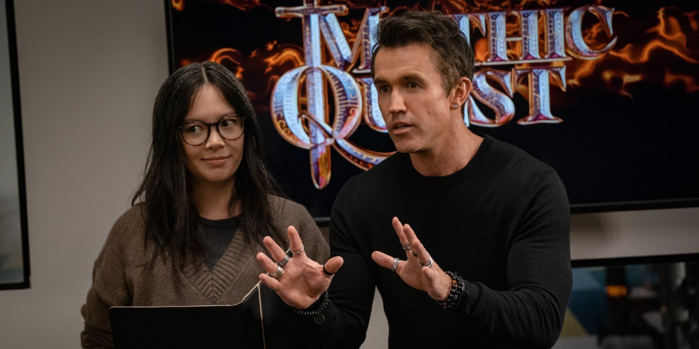 Rob McElhenney presents an idea with Charlotte Nicdao holding a folder beside him in Mythic Quest Season 4.