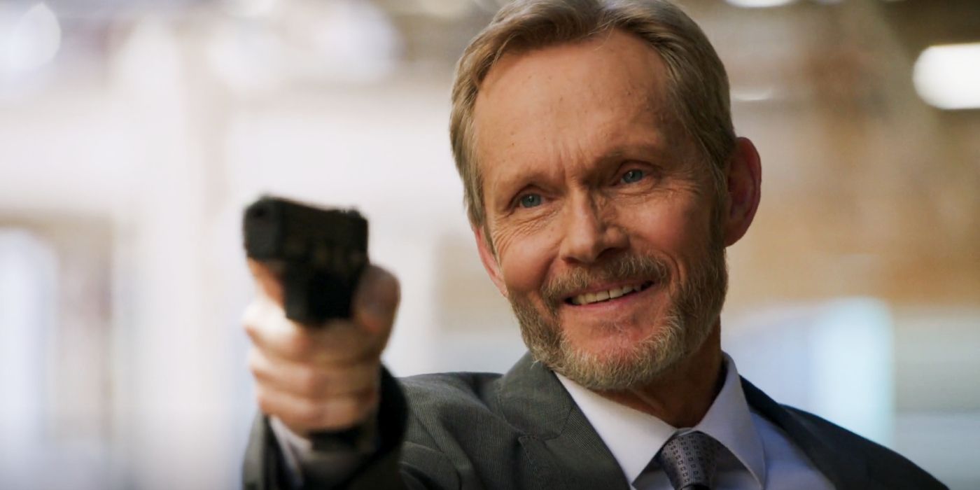 Conrad (Tom Schanley) smiling while pointing a gun in NCIS Season 22, Episode 5