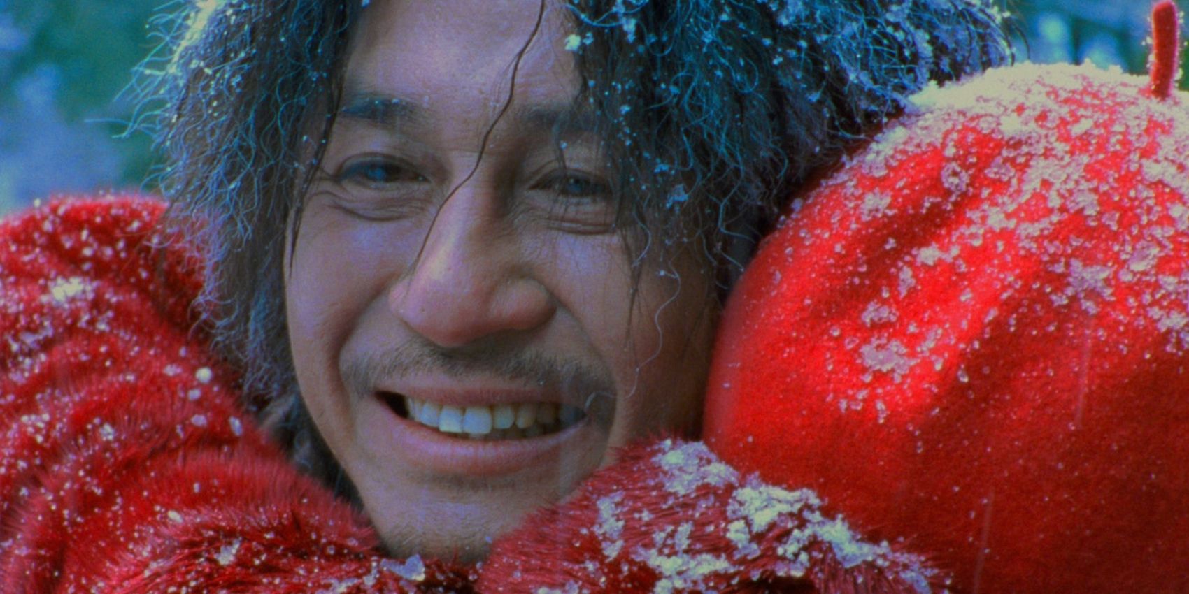 A man hugging someone and smiling in Oldboy