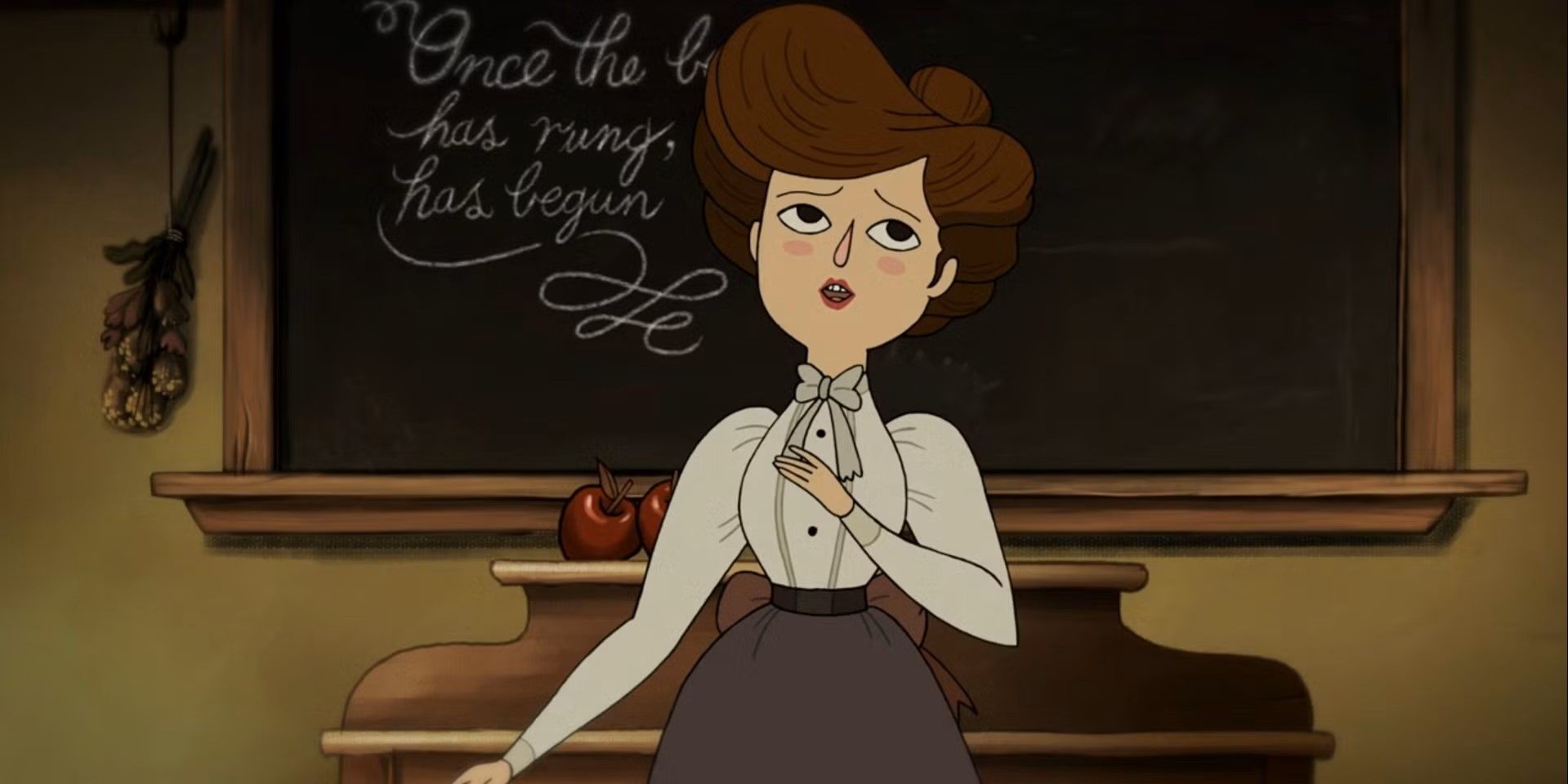 Miss Langtree stands in front of the chalkboard of her classroom