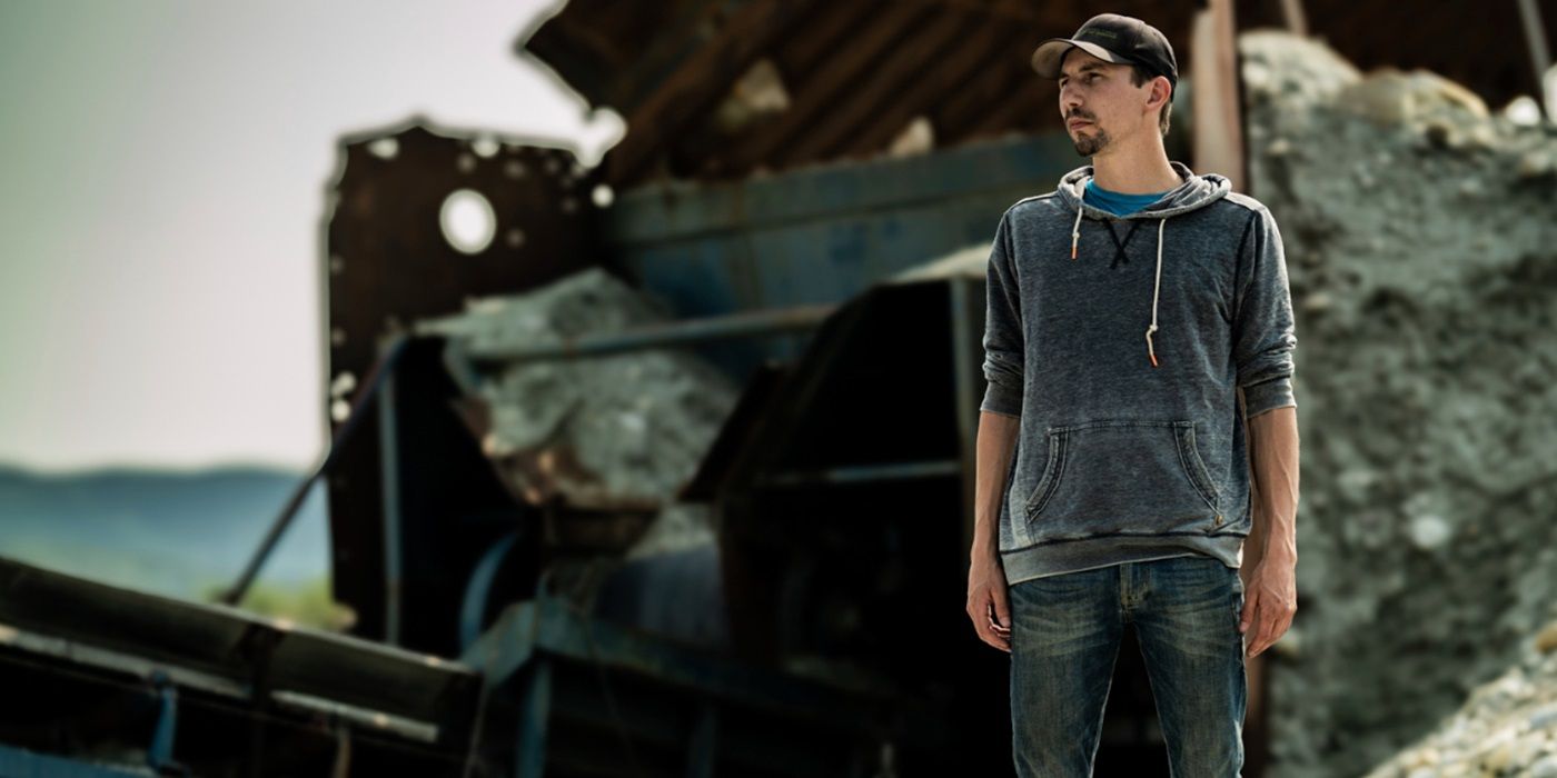 Parker Schnabel posing in front of hopper feeder conveyor in Gold Rush Season 15