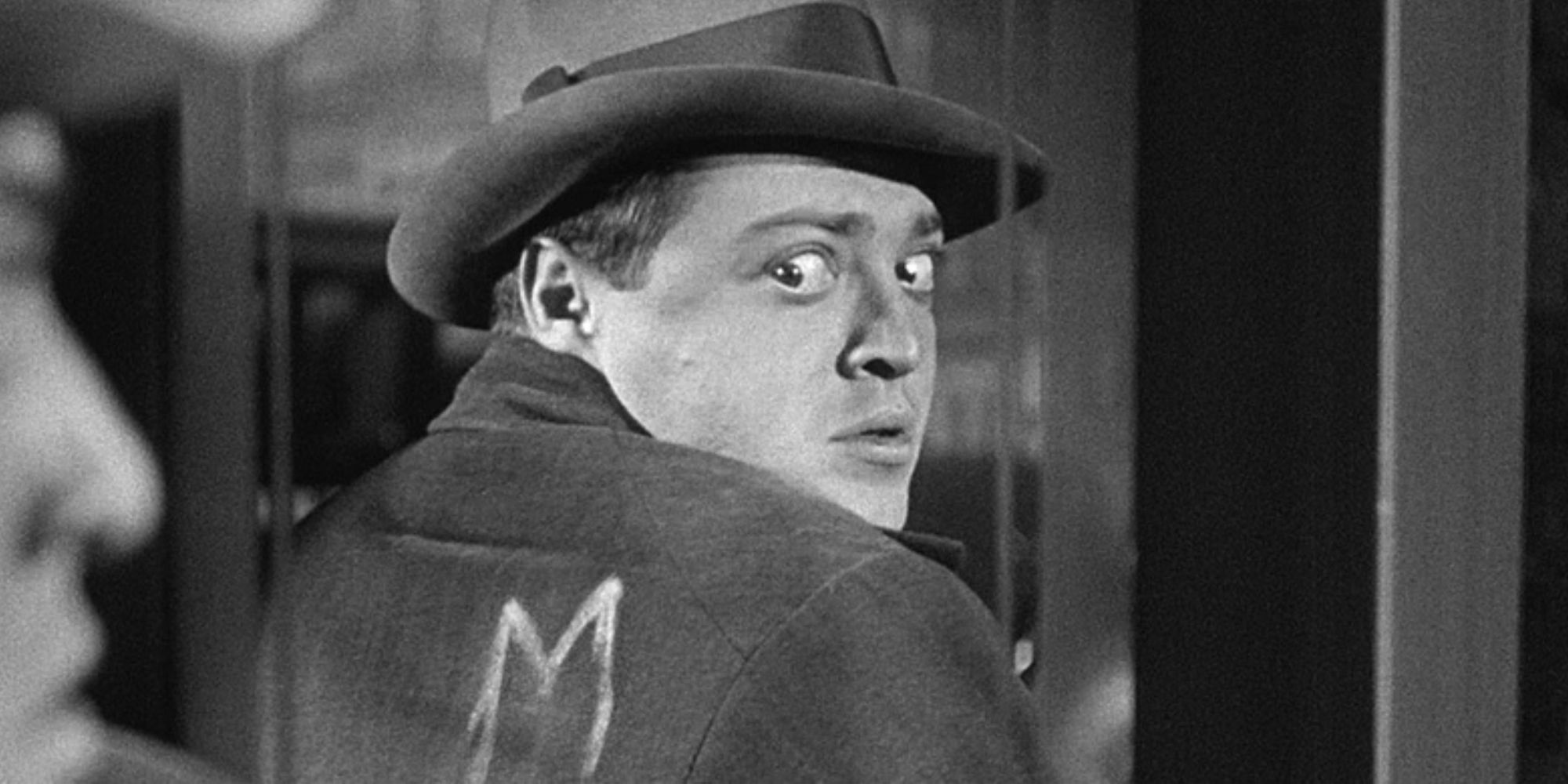 Peter Lorre looking back at his reflection in a window in 'M' (1931)