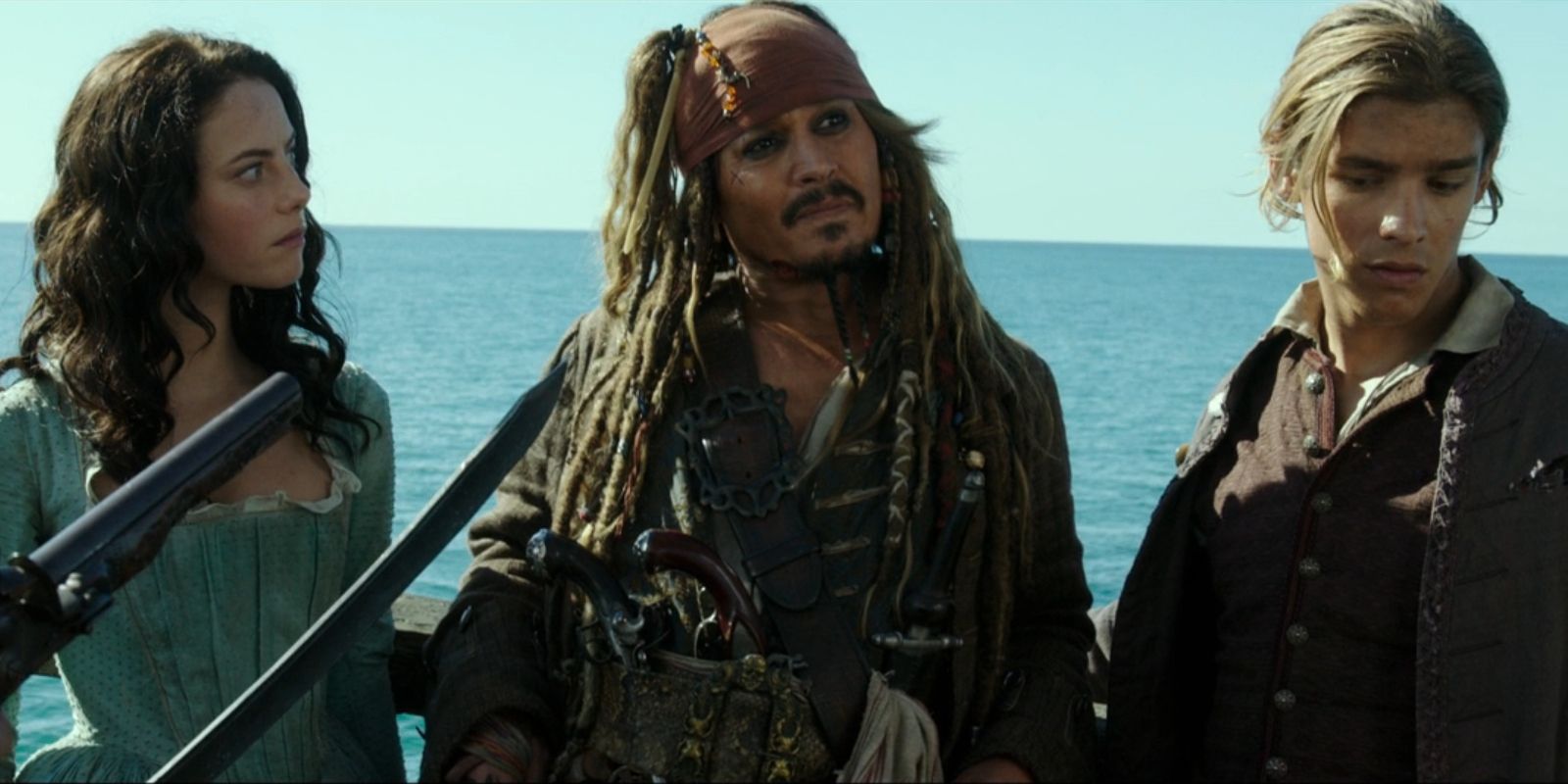 Carina, Jack and Henry stand with a gun and a sword pointed at them in &lsquo;Pirates of the Caribbean: Dead Men Tell No Tales&rsquo;.
