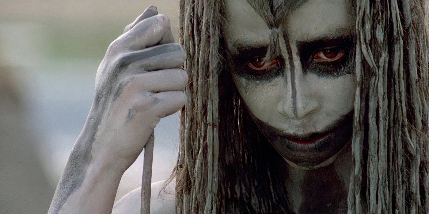 A tribesperson with paint on their face in Quest for Fire