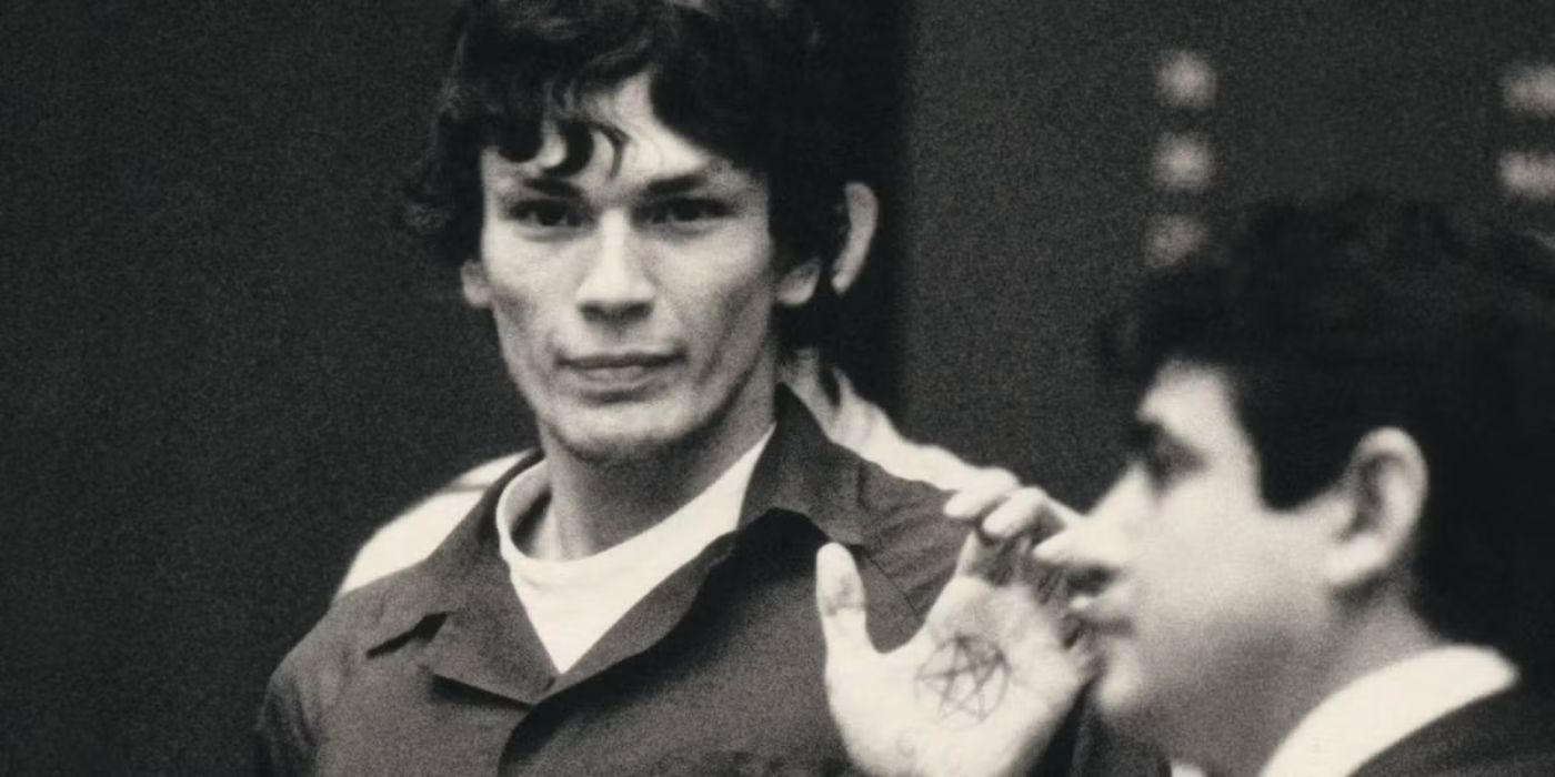 Richard Ramirez  shows off his pentagram hand tattoo in the court room