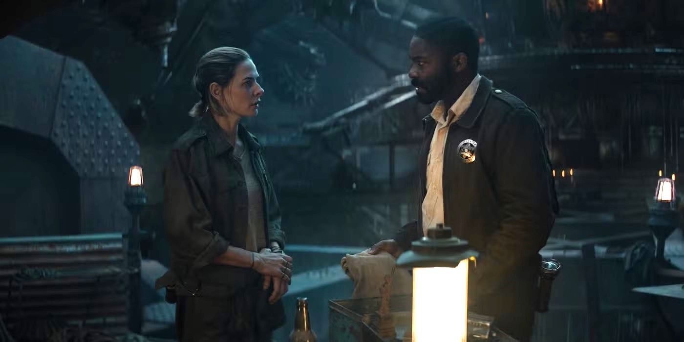 Rebecca Ferguson as Juliette and David Oyelowo as Holston talk in a bunker with a lantern in 'Silo'.