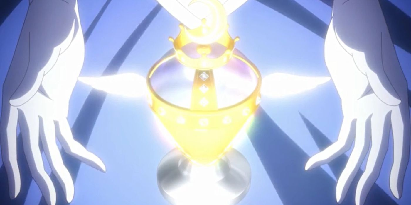 Two white-gloved hands are near a glowing, golden chalice in Sailor Moon.