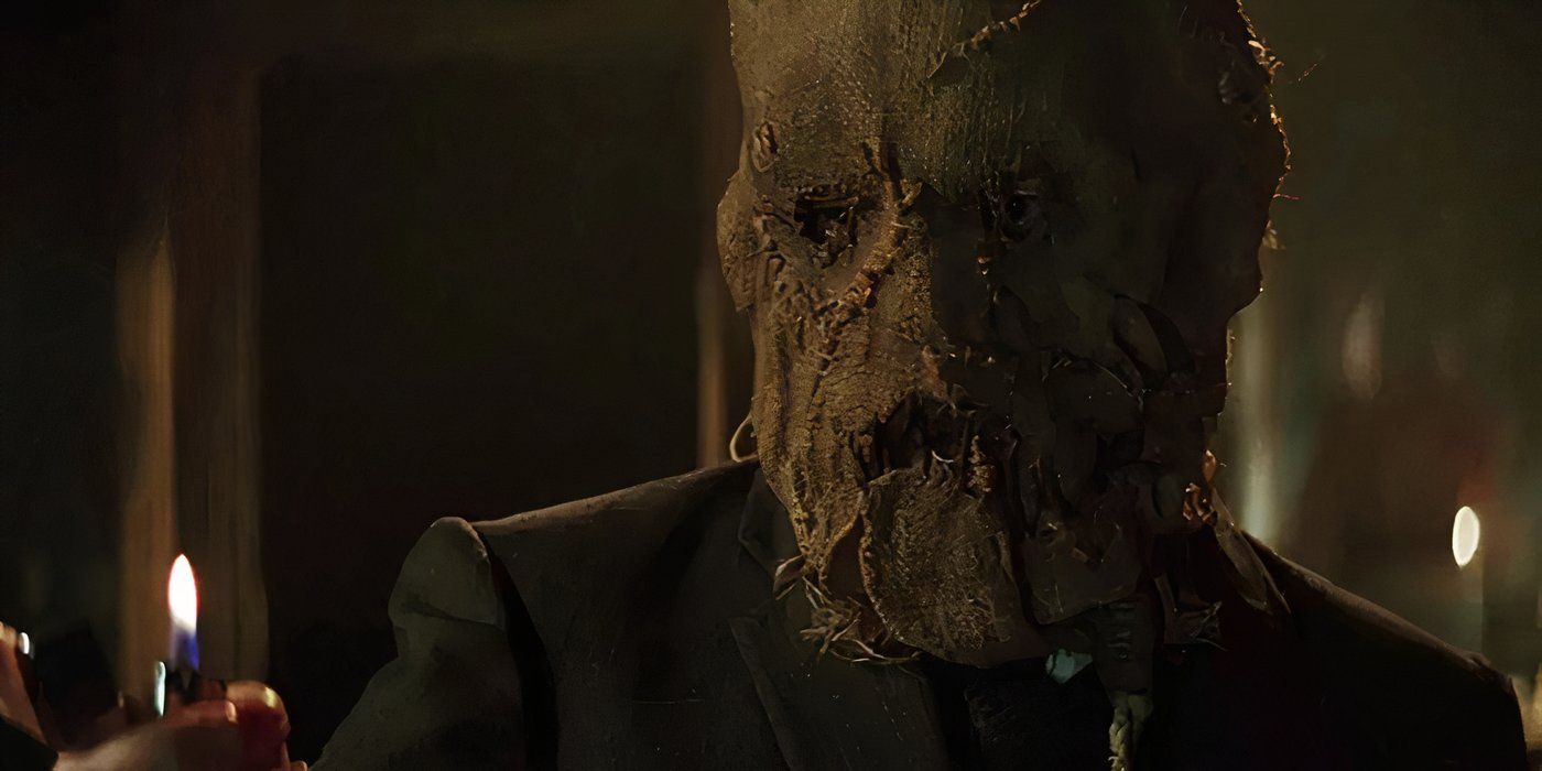 Scarecrow holding a lit lighter in Batman Begins