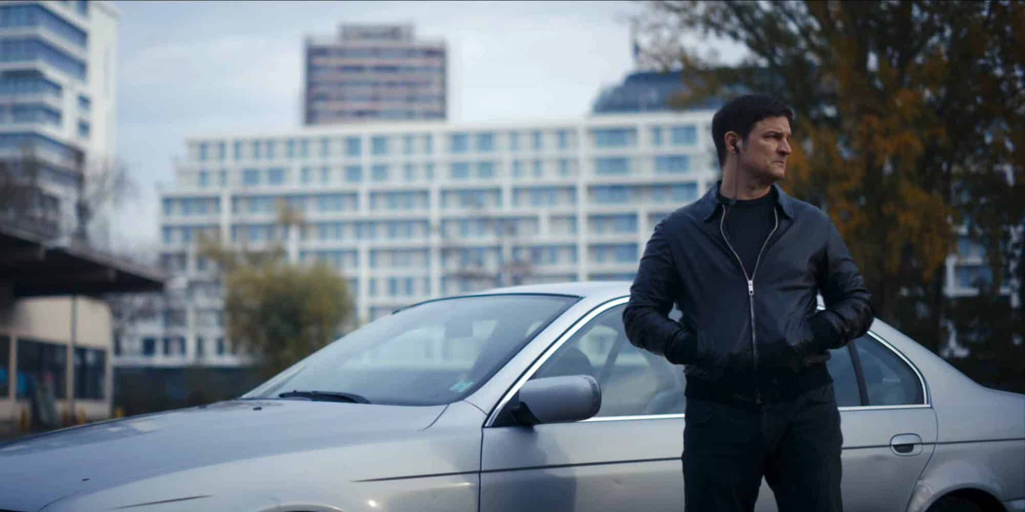 Mišel Matičević as Trojan standing by a car in Scorched Earth