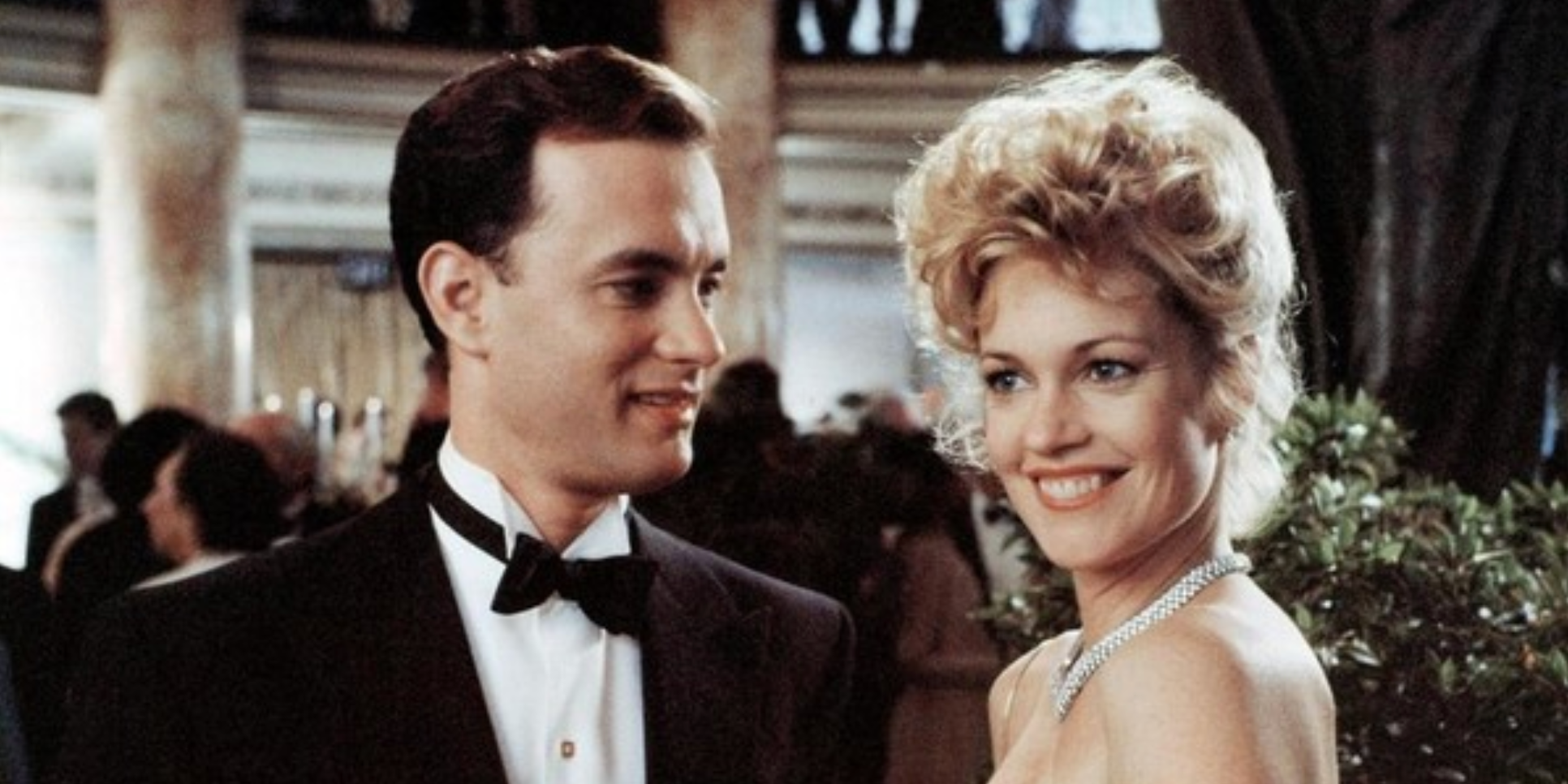 Tom Hanks and Melanie Griffith in fancy clothes and smiling in Bonfire of the Vanities.
