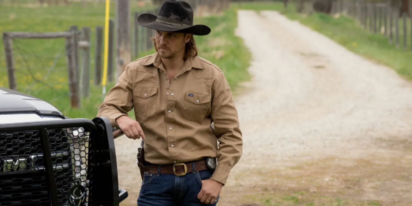 Luke Grimes as Kayce Dutton wearing a tan shirt and cowboy hat standing outside a truck in 'Yellowstone'