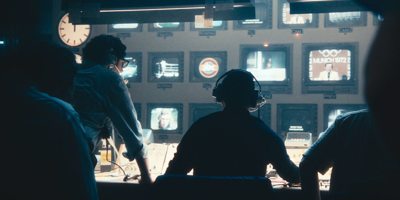 Still of the cast in the control room watching monitors in the dark