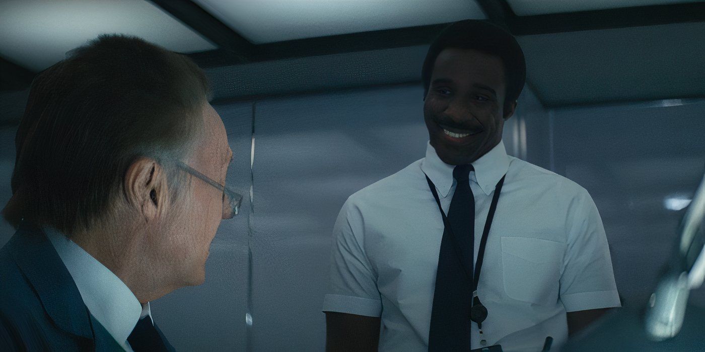 Mr. Milchick (Tramell Tillman) eerily smiles at Burt G. (Christopher Walken) about a surprise for him in 'Severance'.