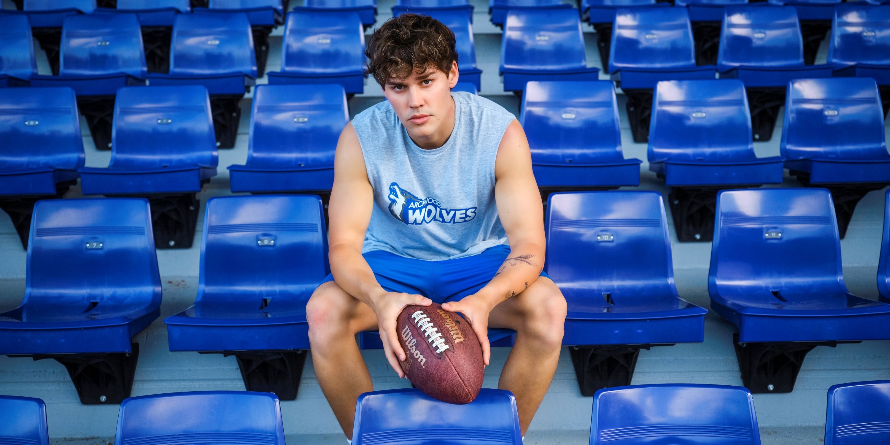 Noah Beck as Drayton Lahey in the seats getting ready for a football game in Sidelined: The QB and Me