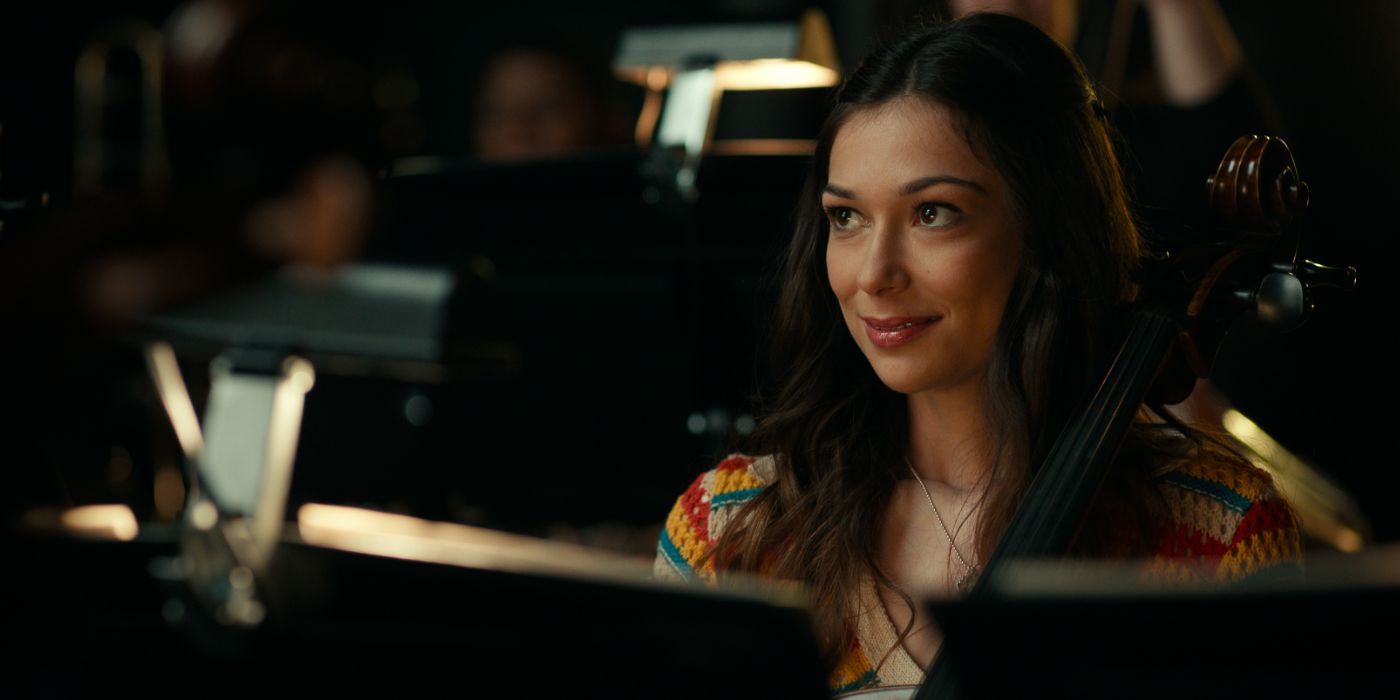 Annamarie Kasper sits in the orchestra and holds her cello in &lsquo;Side Quest&rsquo;