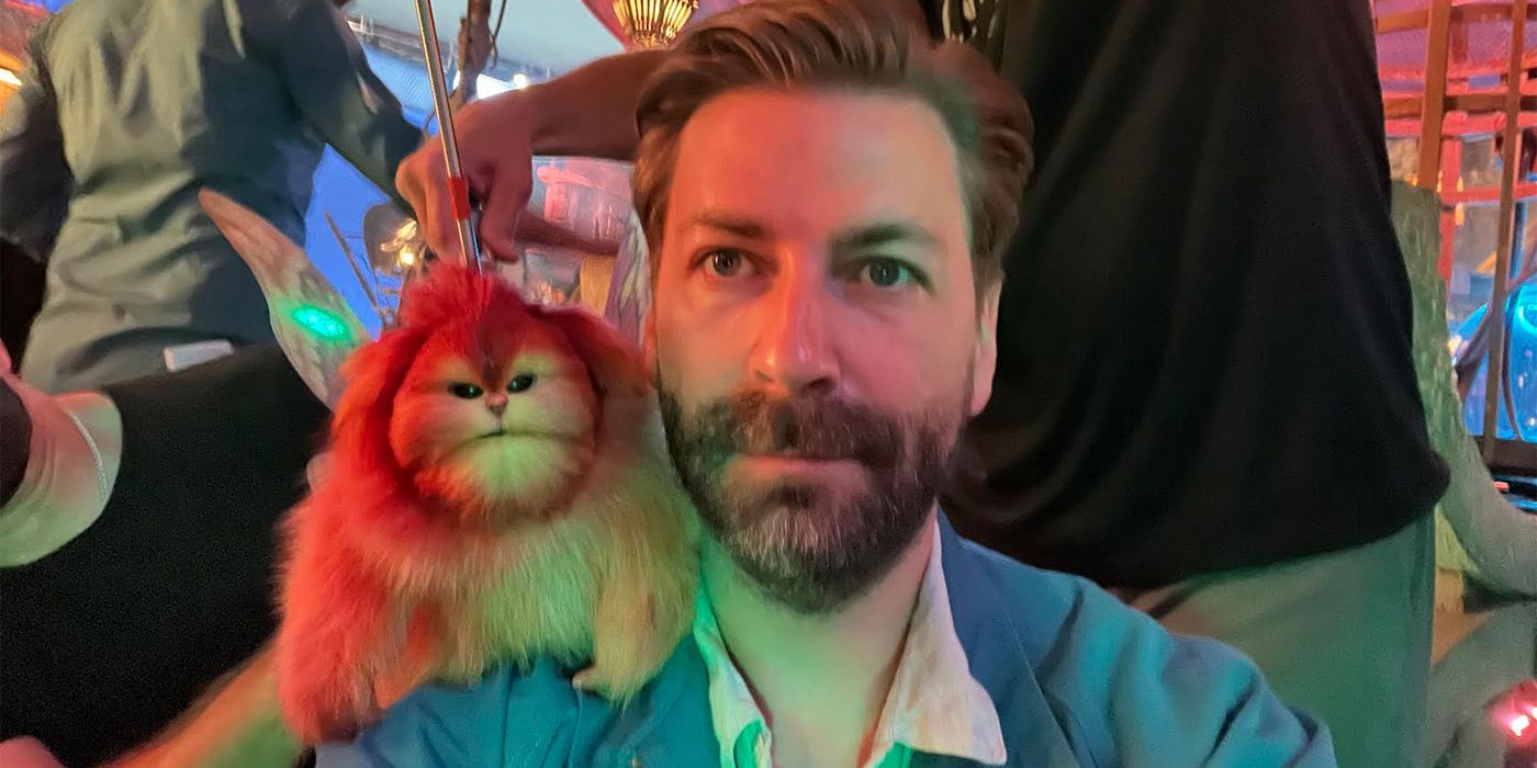 Jon Watts on the set of Skeleton Crew taking a selfie with a creature puppet on his shoulder