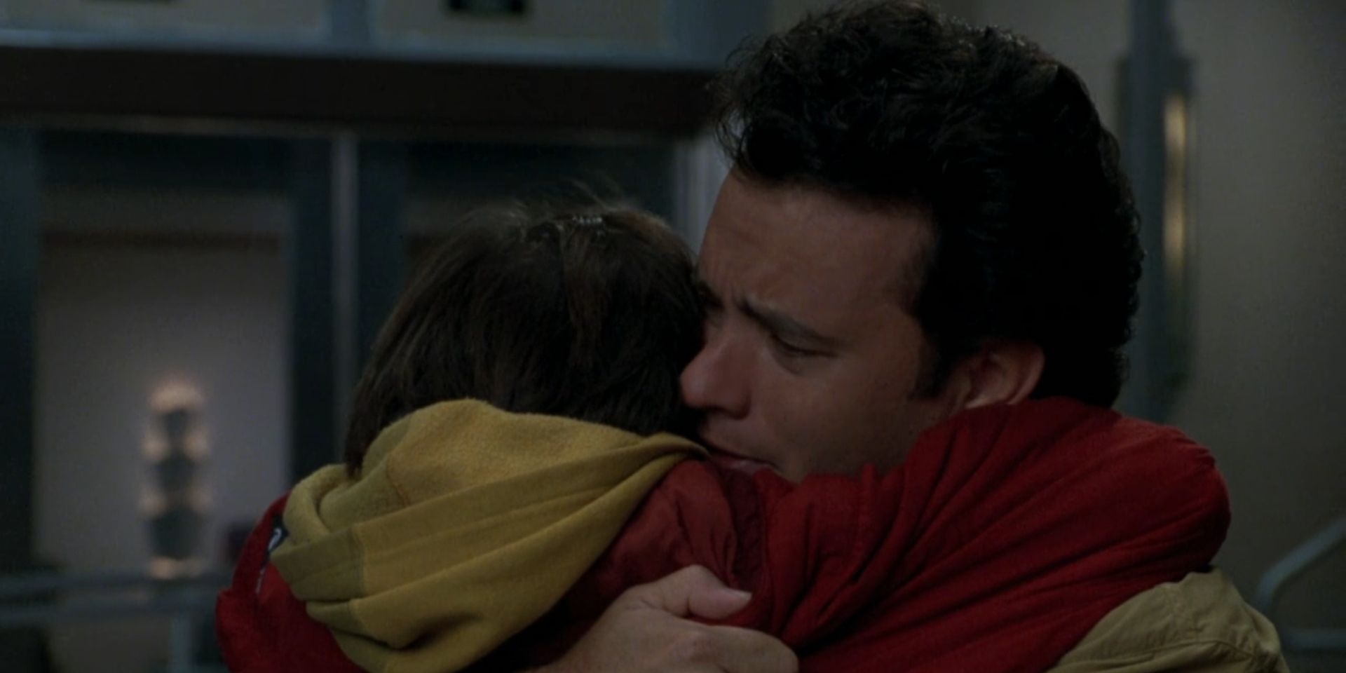 Sam Baldwin, played by Tom Hanks, hugs his son Jonah, played by Ross Malinger in 'Sleepless in Seattle'.