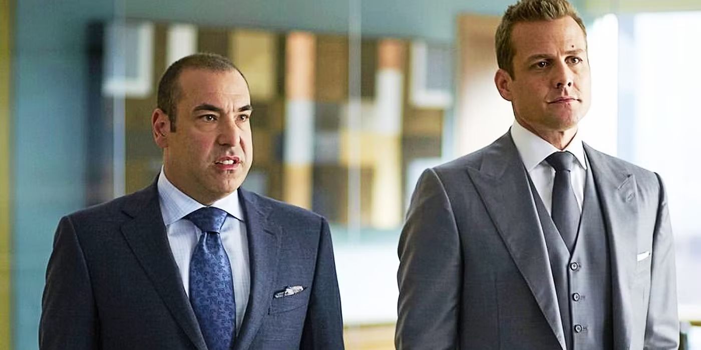 Louis and Harvey standing together in Suits.