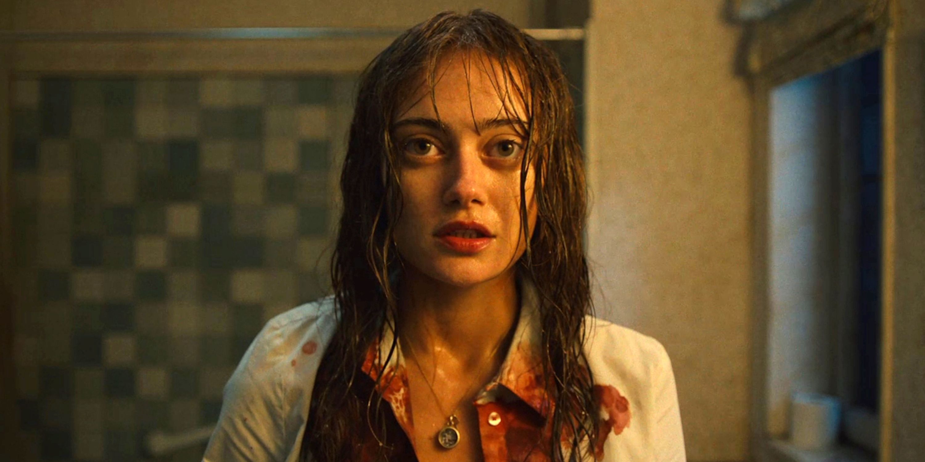 Ella Purnell as Rhiannon in a bloody white shirt staring into the camera in Sweetpea