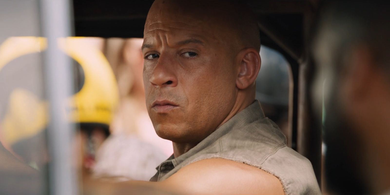 Dominic Toretto, played by Vin Diesel, frowns while sitting in his car in 'The Fate of the Furious'.