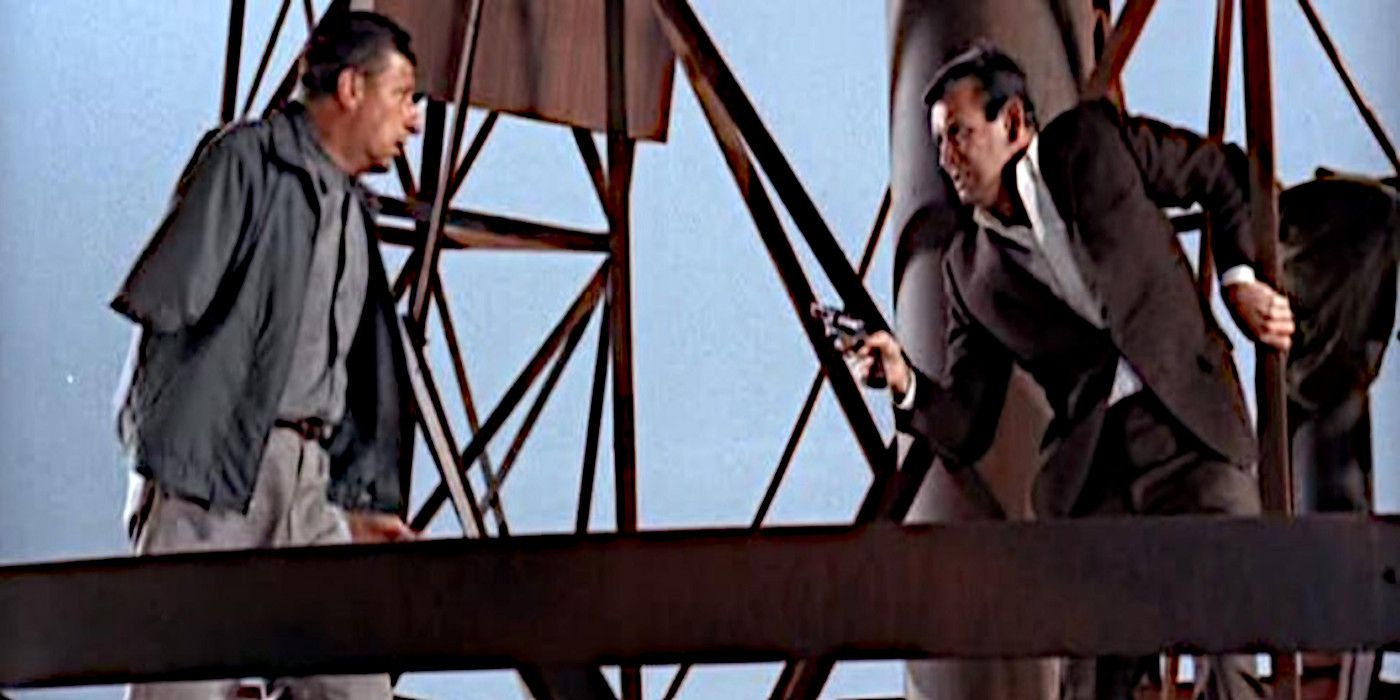 Dr. Kimble points a gun at the one-armed man who killed his wife in The Fugitive.