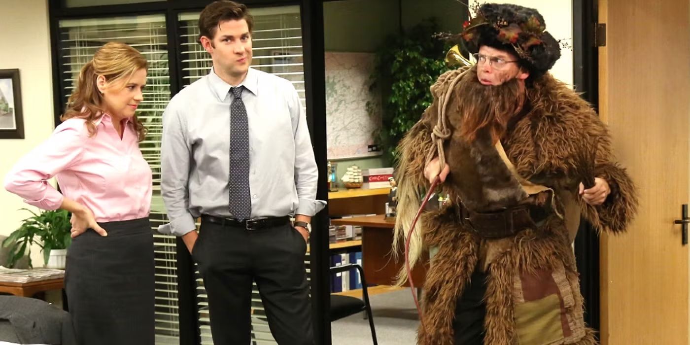 Pam (Jenna Fischer) and Jim (John Krasinski) watch Dwight (Rainn Wilson) Schrute dressed as Belsnickel for Christmas in The Office