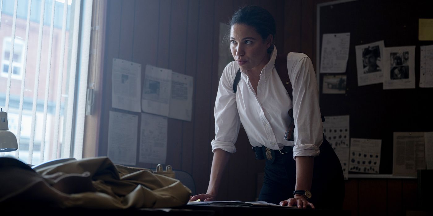 Carney (Jurnee Smollett) leaning on her desk looking up and off-camera