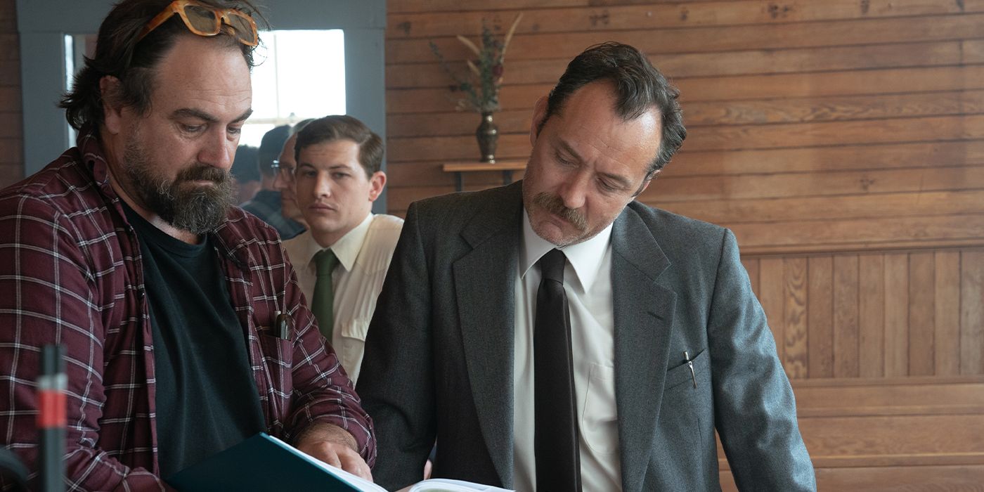 Justin Kurzel on set for The Order going over something in a book with Jude Law