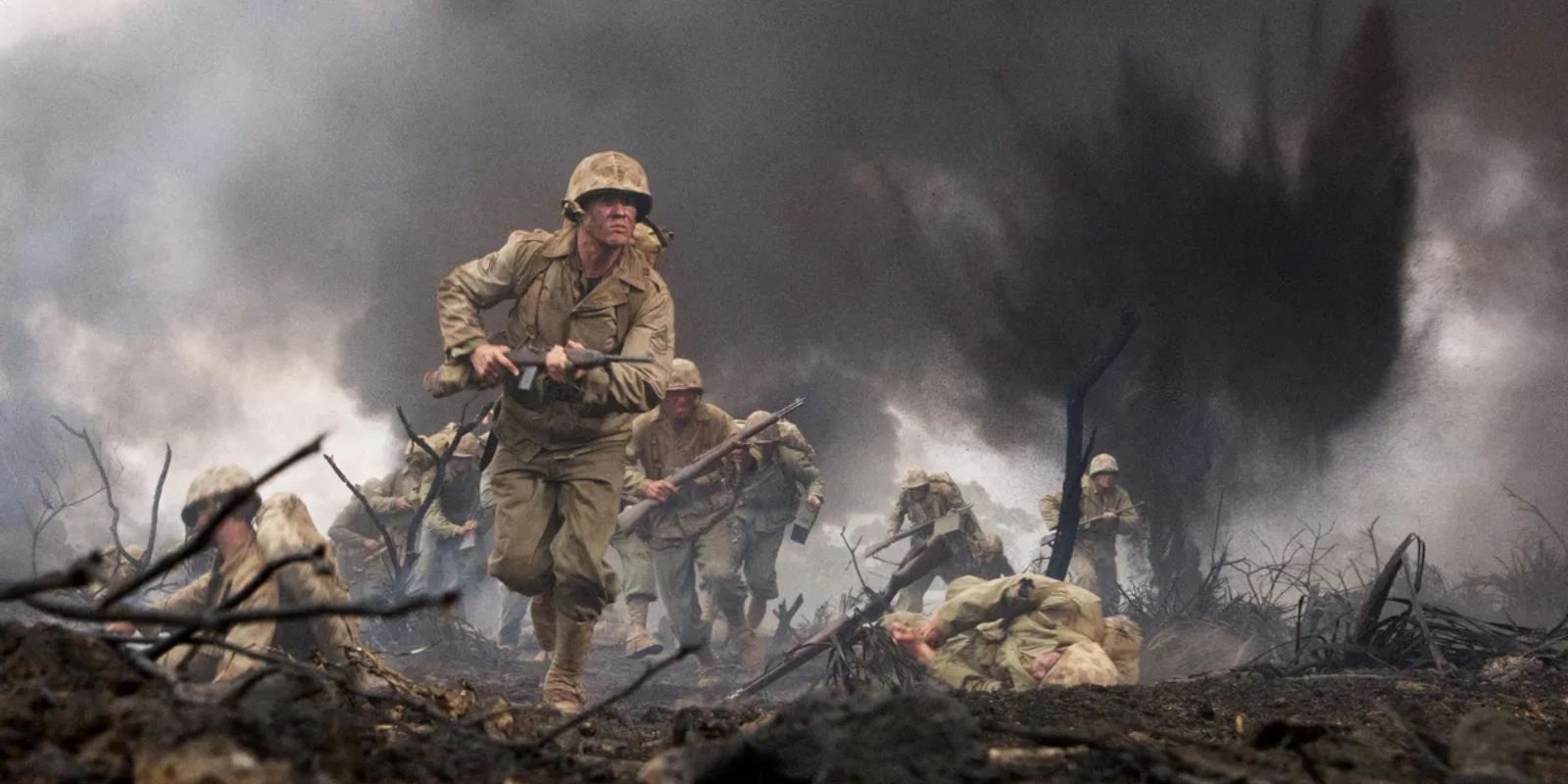 American soldiers run through an explosive war zone as bombs blast around them on a battleground in the Pacific in &lsquo;The Pacific&rsquo; (2010).