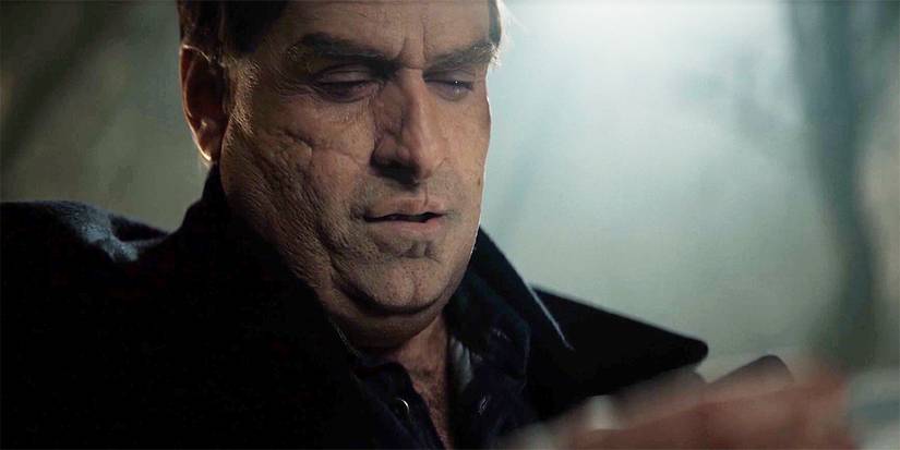 Colin Farrell looking down at something in The Penguin finale.