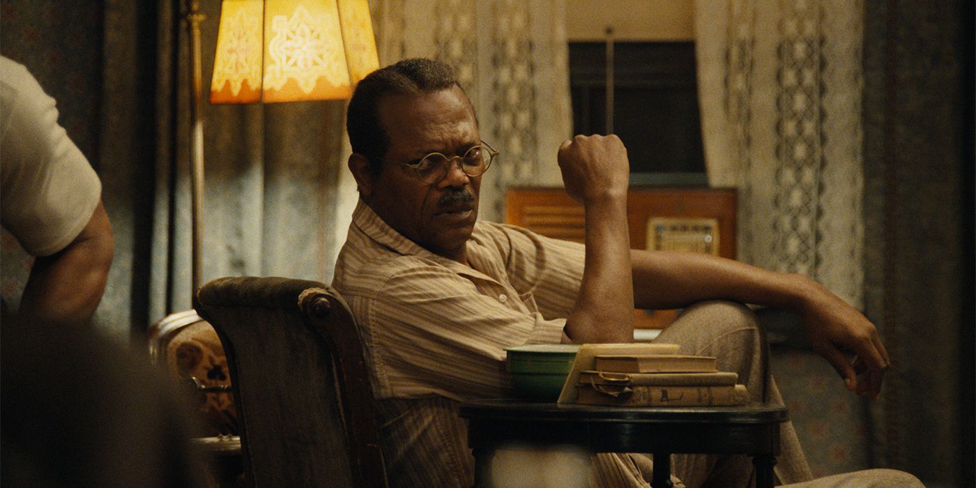 Samuel L. Jackson as Doaker in an armchair looking back with a frown 