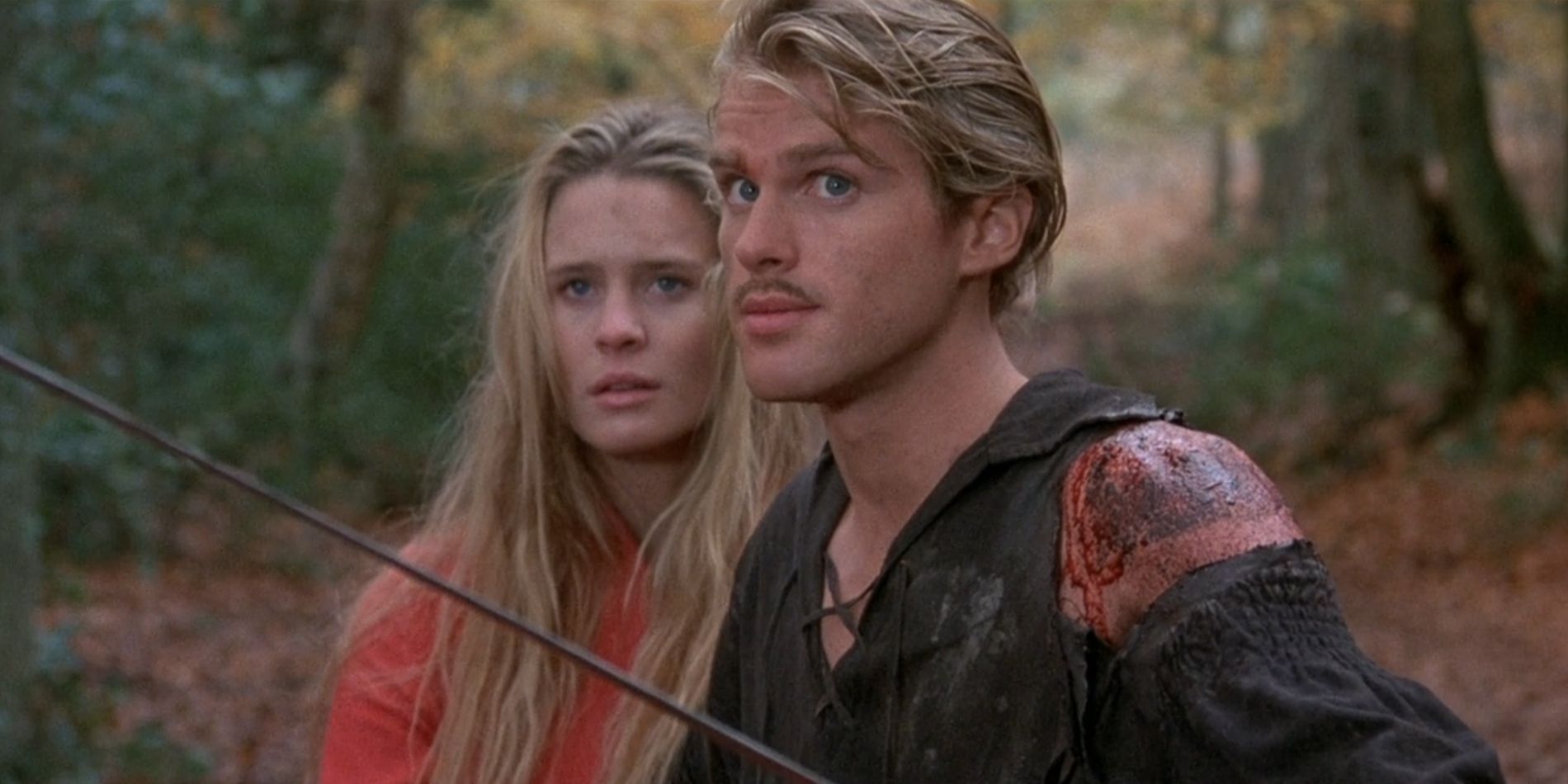 Westley stands on guard with his sword while Buttercup stands behind him in 'The Princess Bride'.