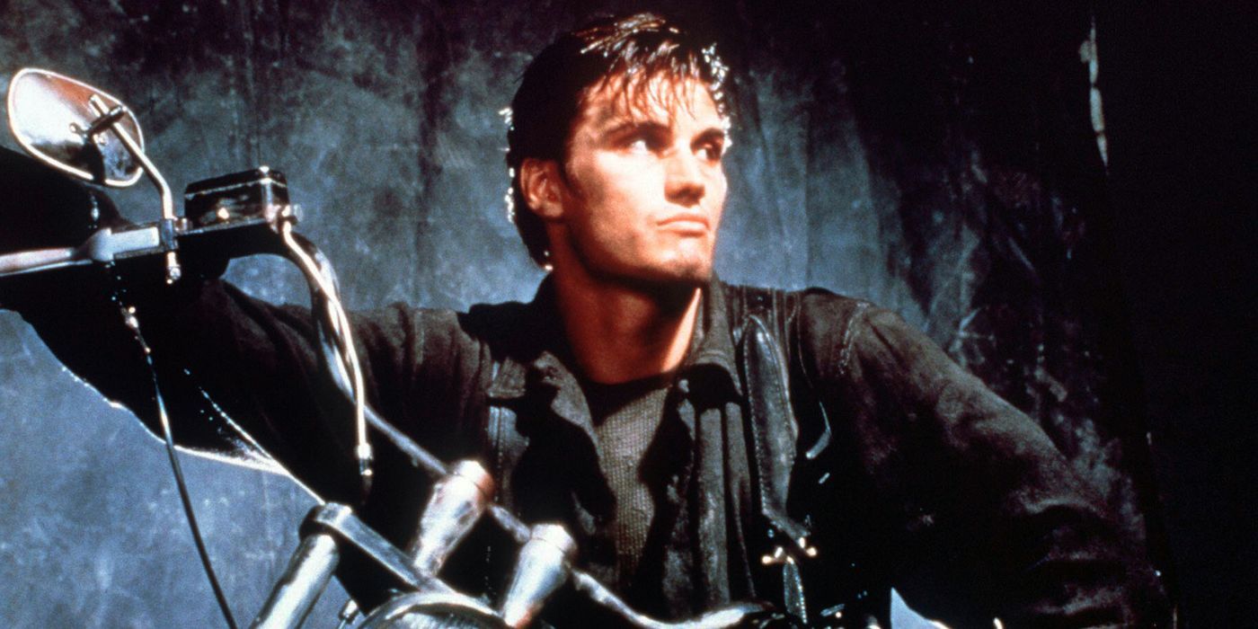 Dolph Lundgren as The Punisher sits on a motorcycle and looks off-camera in The Punisher.