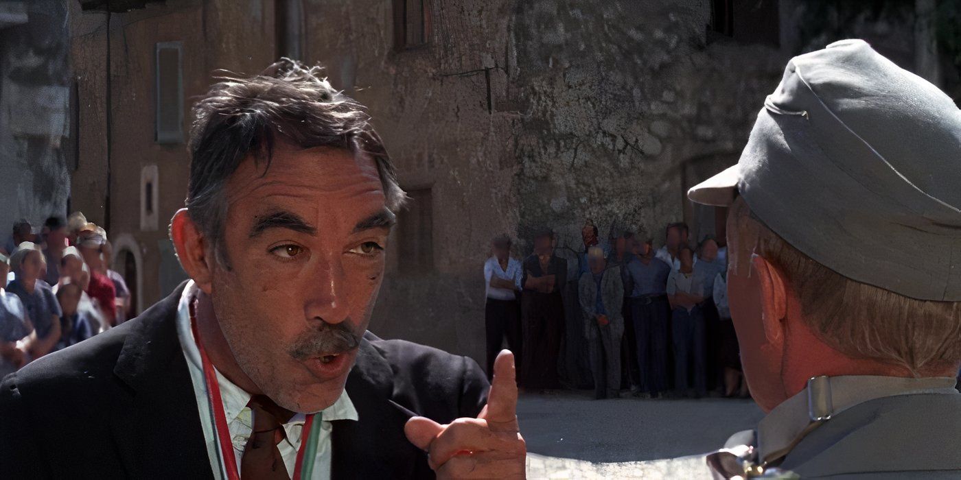 Anthony Quinn as Italo Bombolini points at a man in uniform and argues in The Secret of Santa Vittoria.