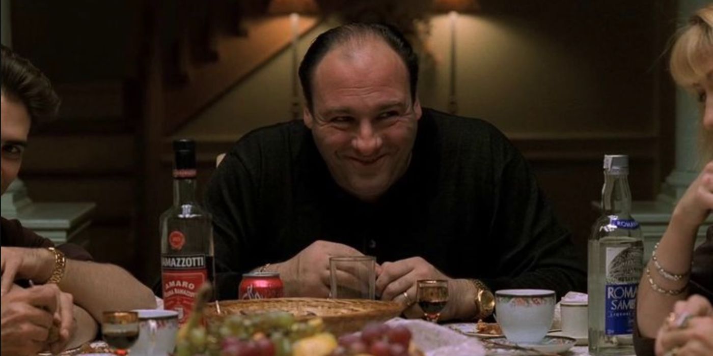 Tony Soprano smiling at the dinner table during an episode of The Sopranos.
